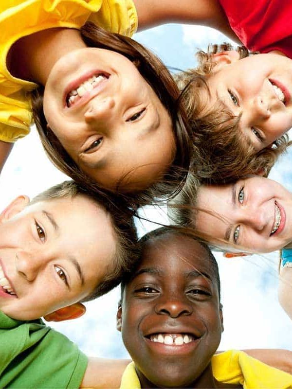 A group of diverse children playing outside. A group of diverse children playing outside.